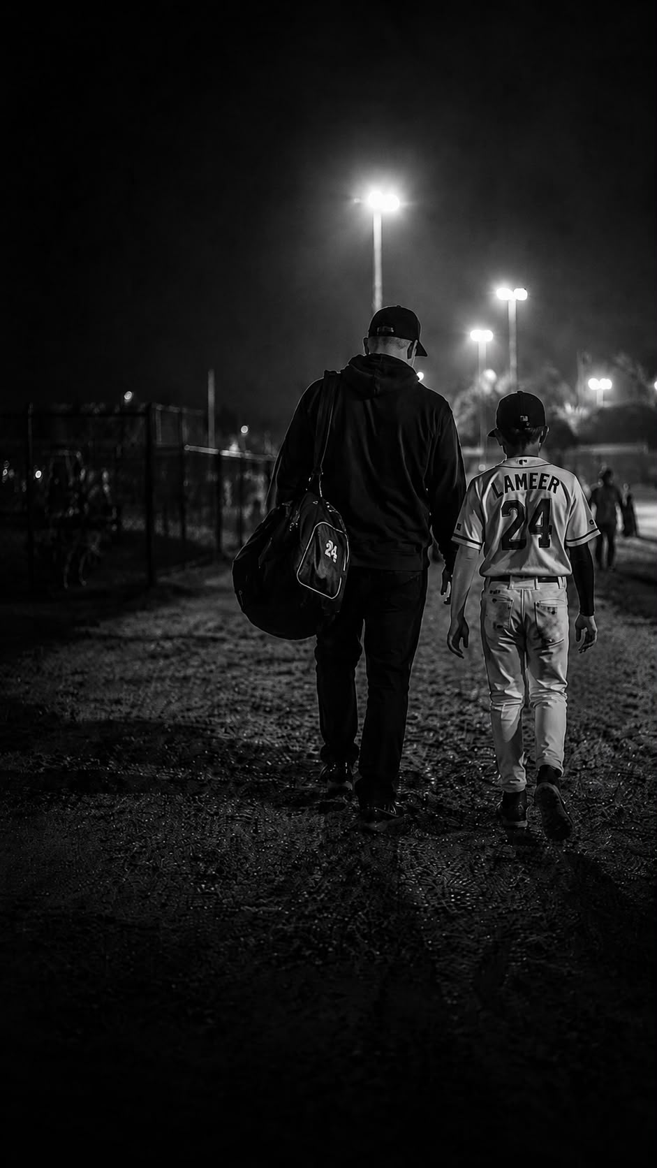 Father and son walking off the field